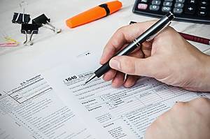 Man filling US tax form. tax form us business income office hand fill concept