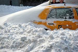 nyc taxi covered in snow snow
