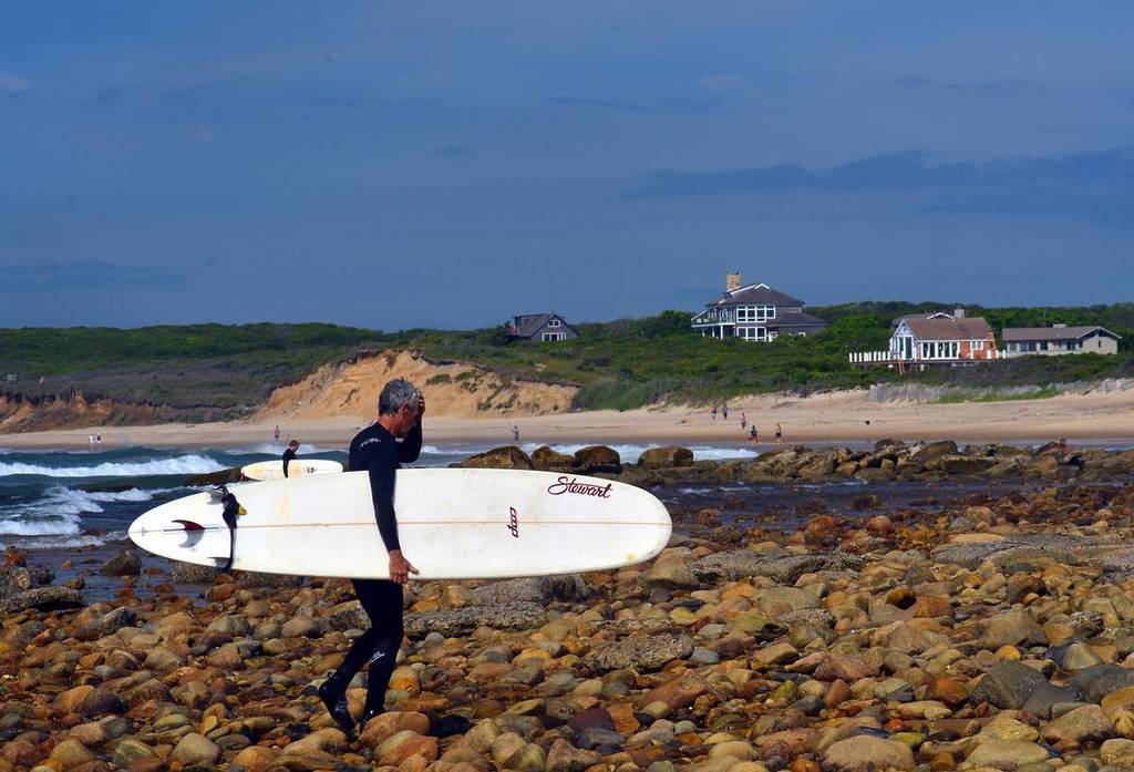 MONTAUK, NEW YORK-JUNE 13: Unidentified senior surfer with surfboard on Ditch Plains surfing beach, Altantic Ocean is seen on June 13, 2015. 