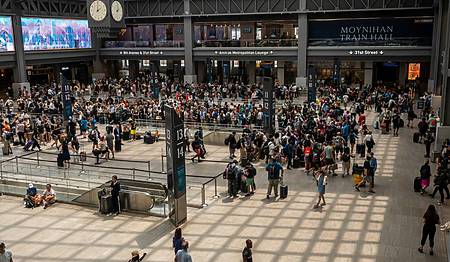 Travelers crowd the Moynihan Train Hall in Pennsylvania Station in New York getting an early start to a summer weekend