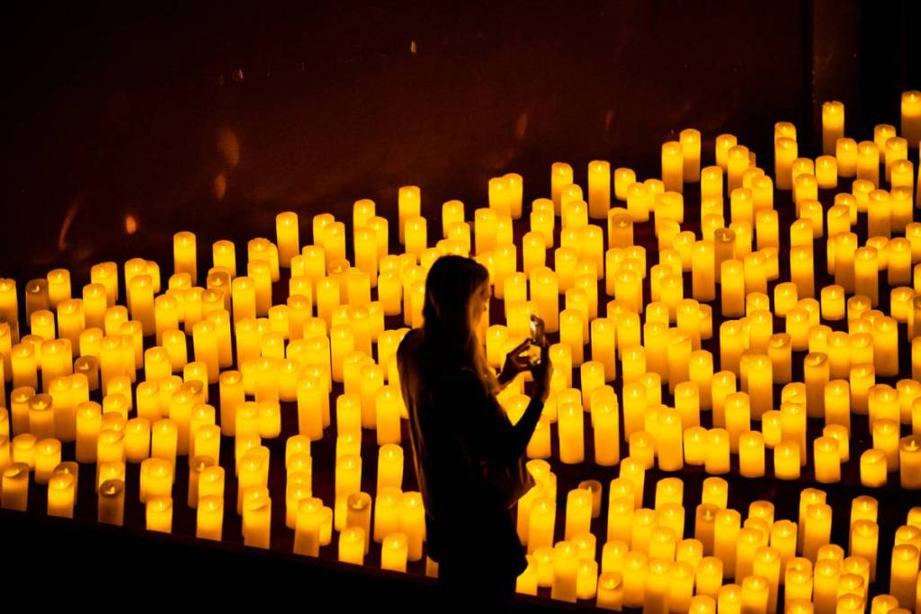 A woman taking pitcture at a Candlelight concert