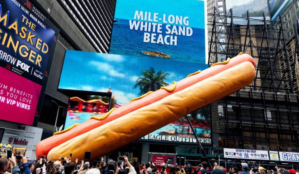 The world’s largest hot dog just returned to Times Square—and this 65-foot sculpture blasts visitors with confetti daily