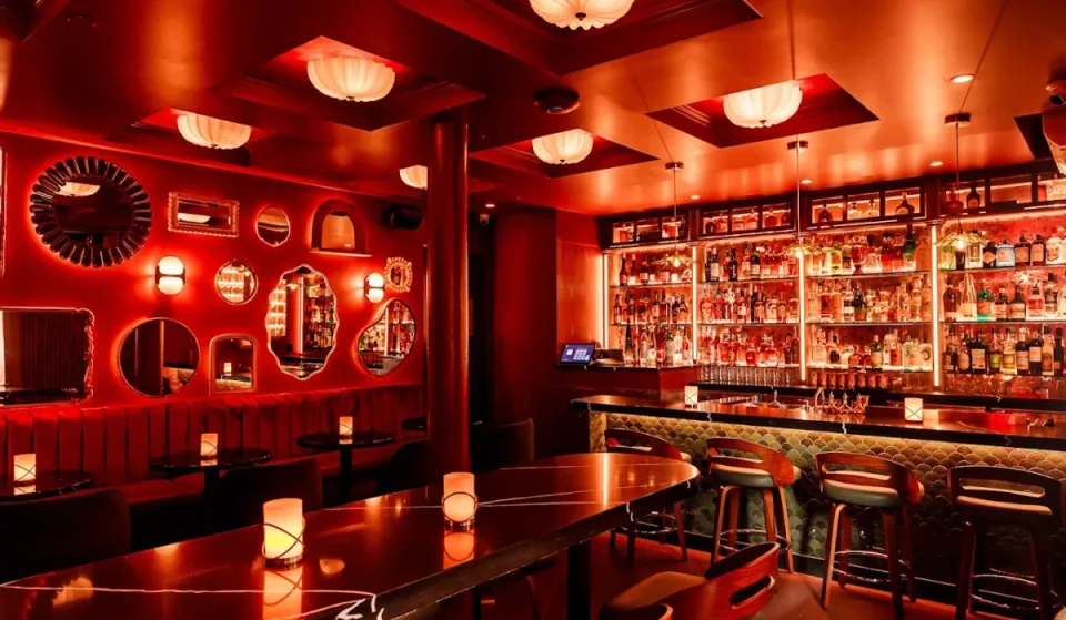 Tucked behind a heavy metal door on 2nd Ave, NYC’s hidden speakeasy pairs bold-spiced oysters and reimagined cocktails with live ’90s jazz and red tarot readings