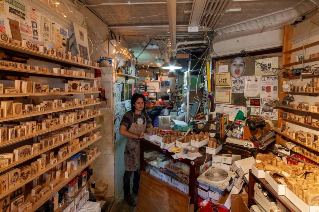 Nell’East Village di New York, un negoziante di 76 anni gestisce l’ultimo negozio di timbri in gomma della città in una “città di disadattati”, dopo quasi cinque decenni