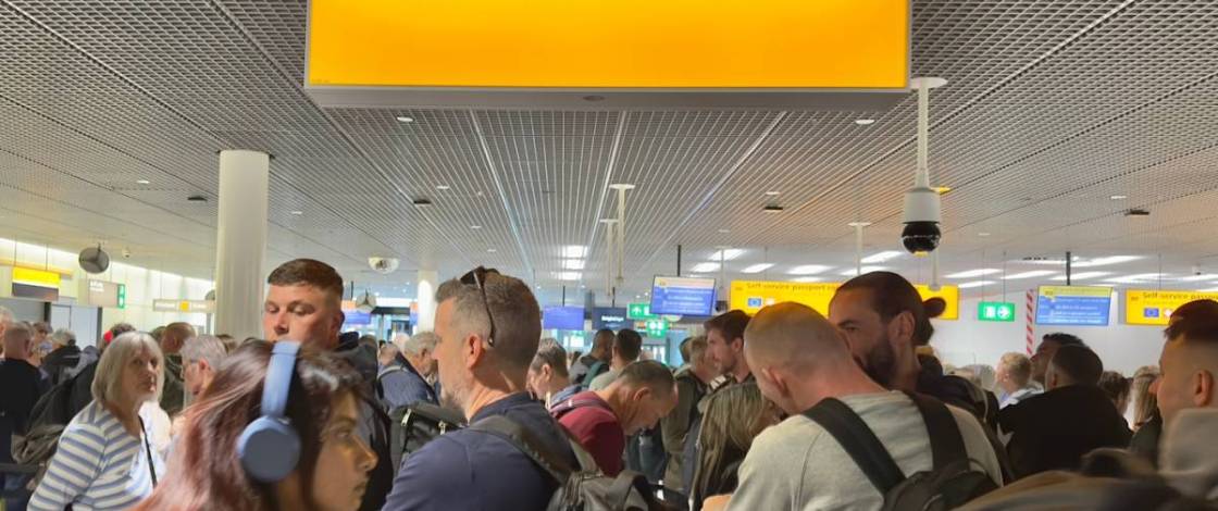 group of people outside passport control at an airport
