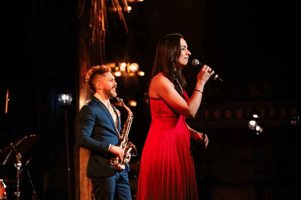 women performs at the jazz room in long red dress