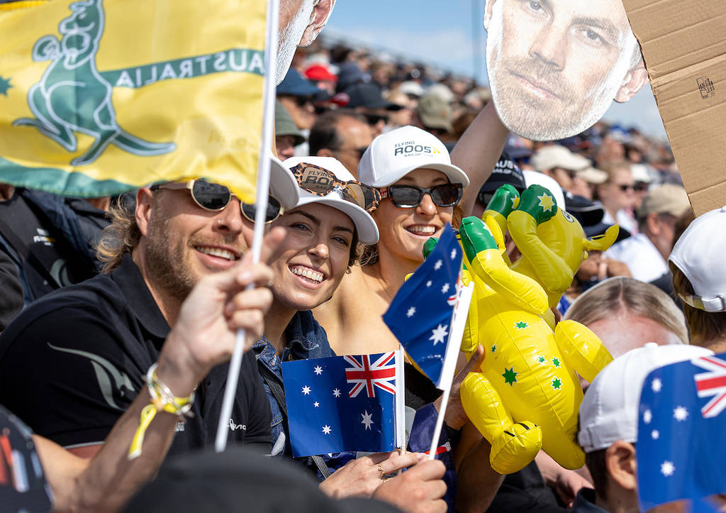 A close-up shot of the crowd cheering with inflatable kangaroos and head cut-outs of the Sail GP athletes.