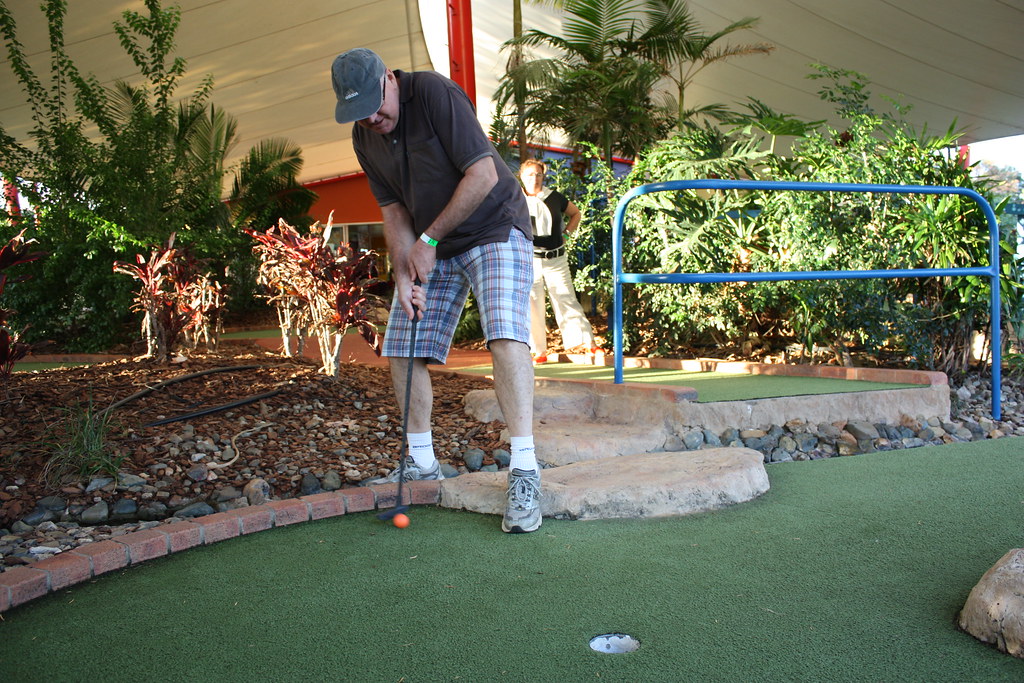 man plays mini golf
