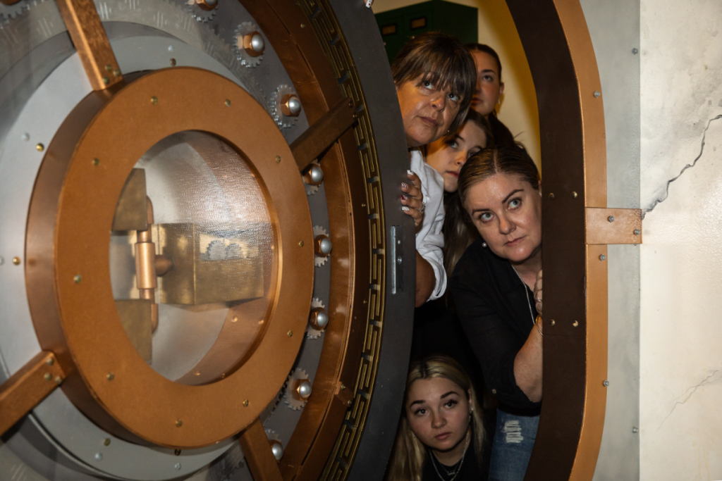 A group of friends emerge from a bank vault at Escape This.