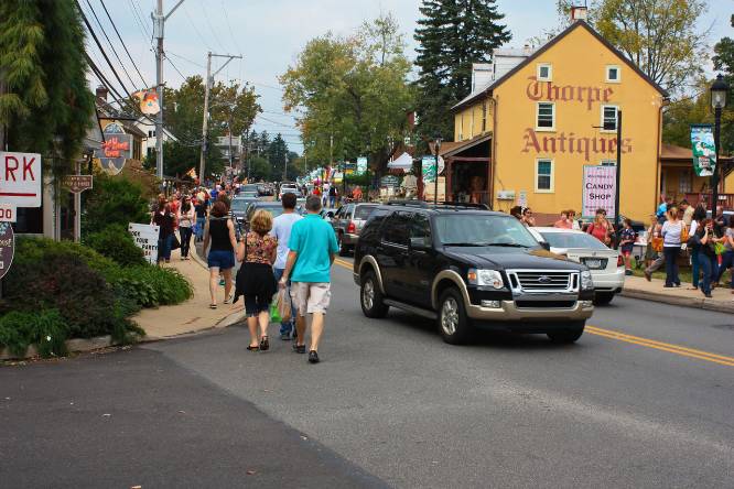 people walking during fall fall in this charming town