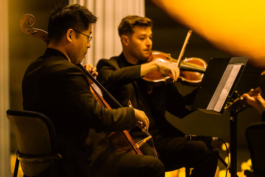 A violinist and a cellist perform at a Candlelight concert.