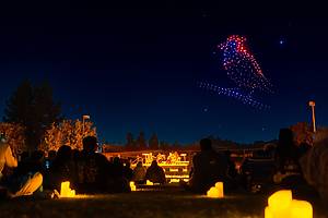 Illuminated drones fly over an illuminated string quartet