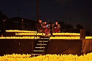 Illuminated drones fly over an illuminated string quartet