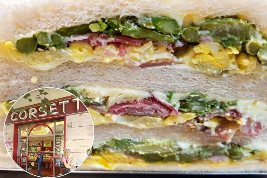 Il celebre tramezzino artigianale Spargio di Corsetti Gastronomia a Roma con asparagi e uovo, e un riquadro sulla facciata del locale storico.