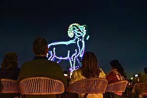 Drones light up the sky over a string quartet