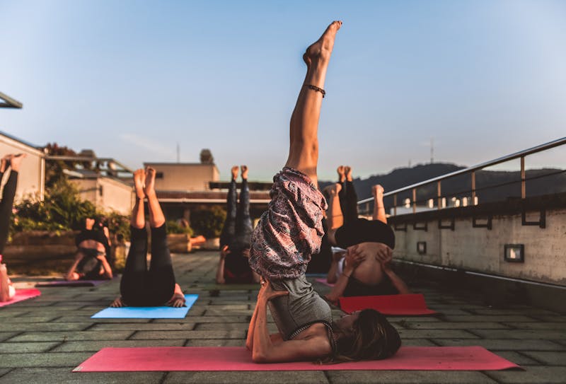 women practicing yoga on a rooftop