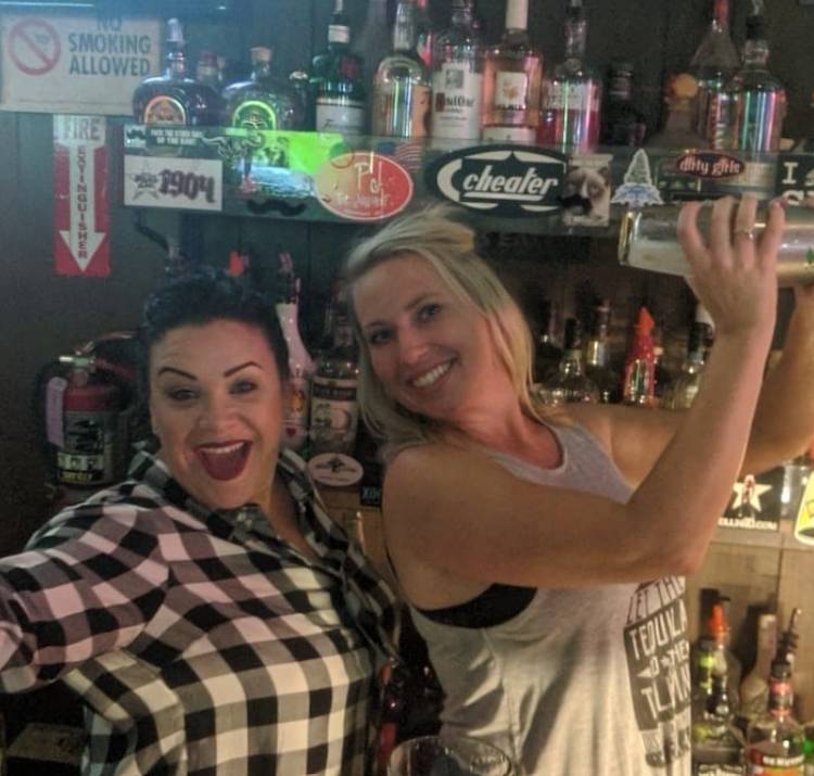 women behind a bar at a dive bar