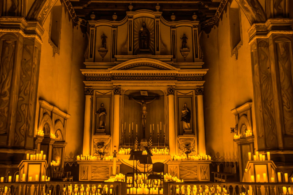 The nave at Mission San Luis lit up by Candlelight