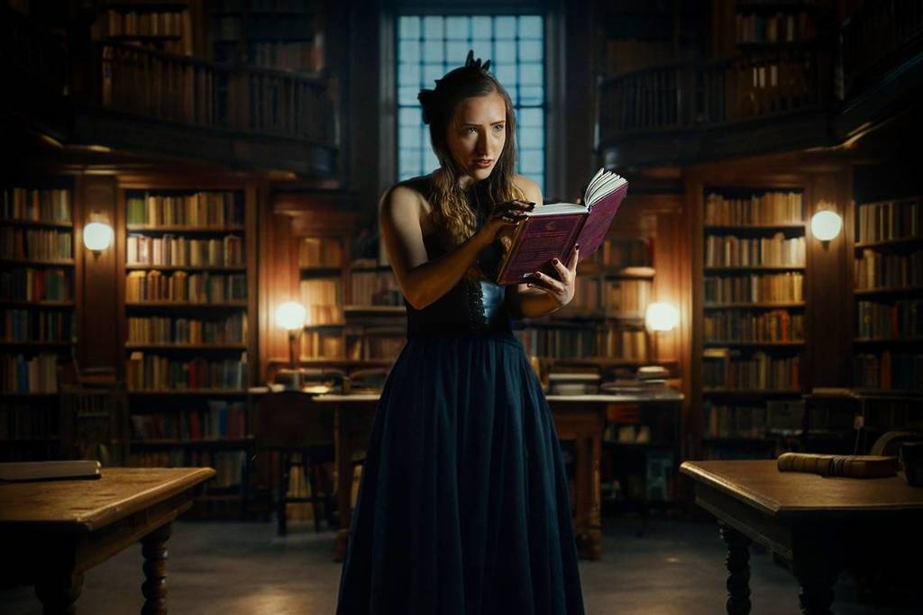 woman reading in dimly lit library