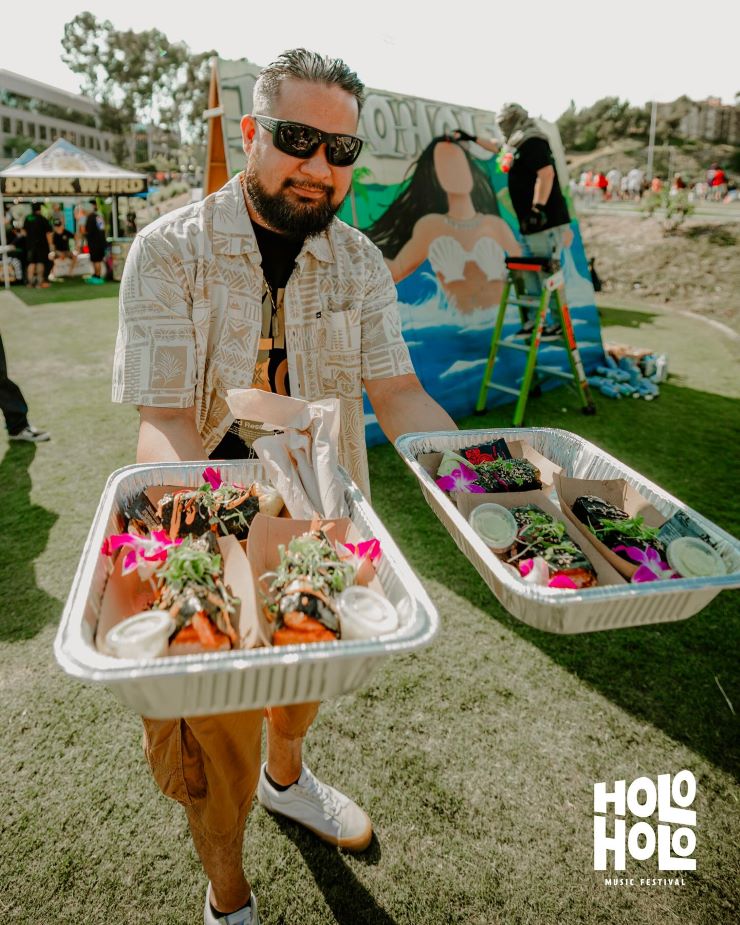 person with food at Holo Holo festival
