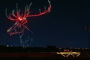 Illuminated drones fly over a string quartet