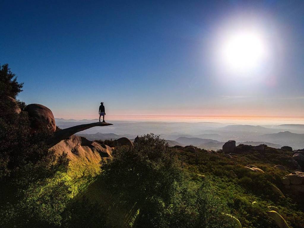 person on edge of Potato Chip Rock in Ramona San Diego