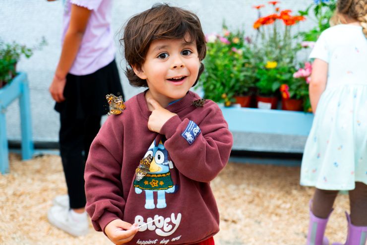 child with butterflies at Carlsbad Flower Fields butterfly experience