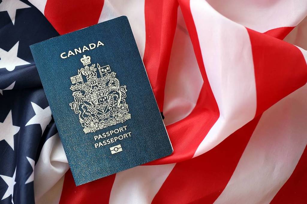 Canadian passport on US flag