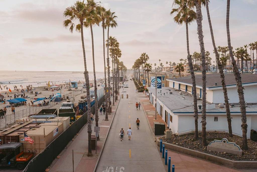 people walking at running by the beach in San Diego