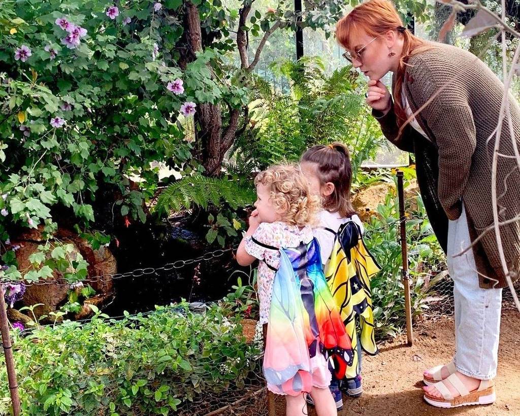 woman with children looking at plants