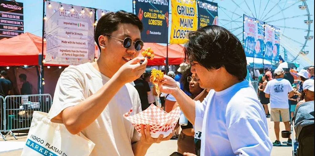 2 guys enjoying food at FoodieLand