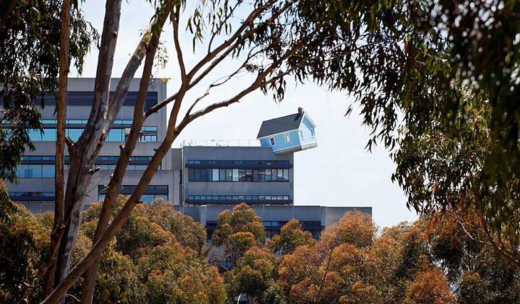 Una casa azul claro de 32 toneladas se balancea al borde de un edificio de ingeniería de la UC San Diego, y de hecho puedes entrar en su interior inclinado
