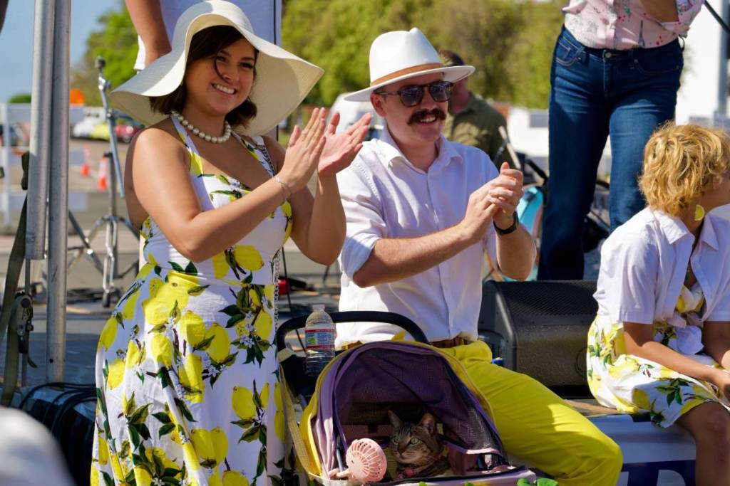 people with lemon-themed outfits clapping
