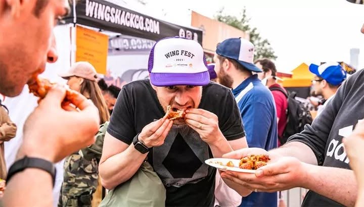 man eating chicken wings 