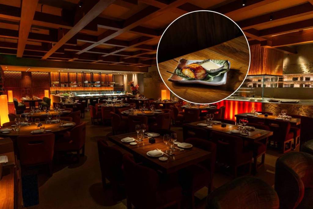 inside a wooden, brown restaurant with a close up of a piece of sushi