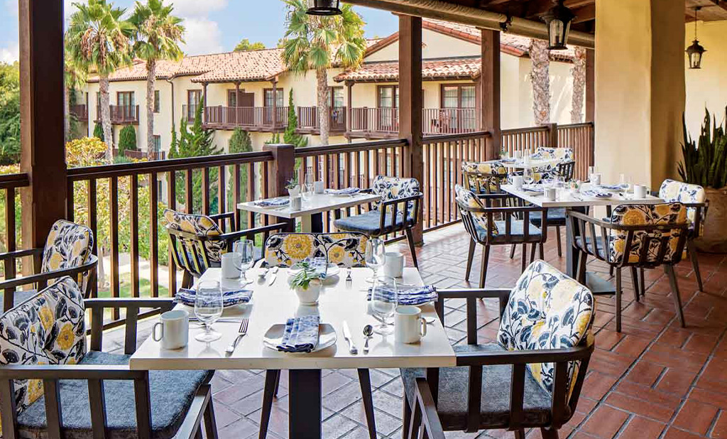 Elegant tables set up for service at Estancia La Jolla Hotel's restaurant