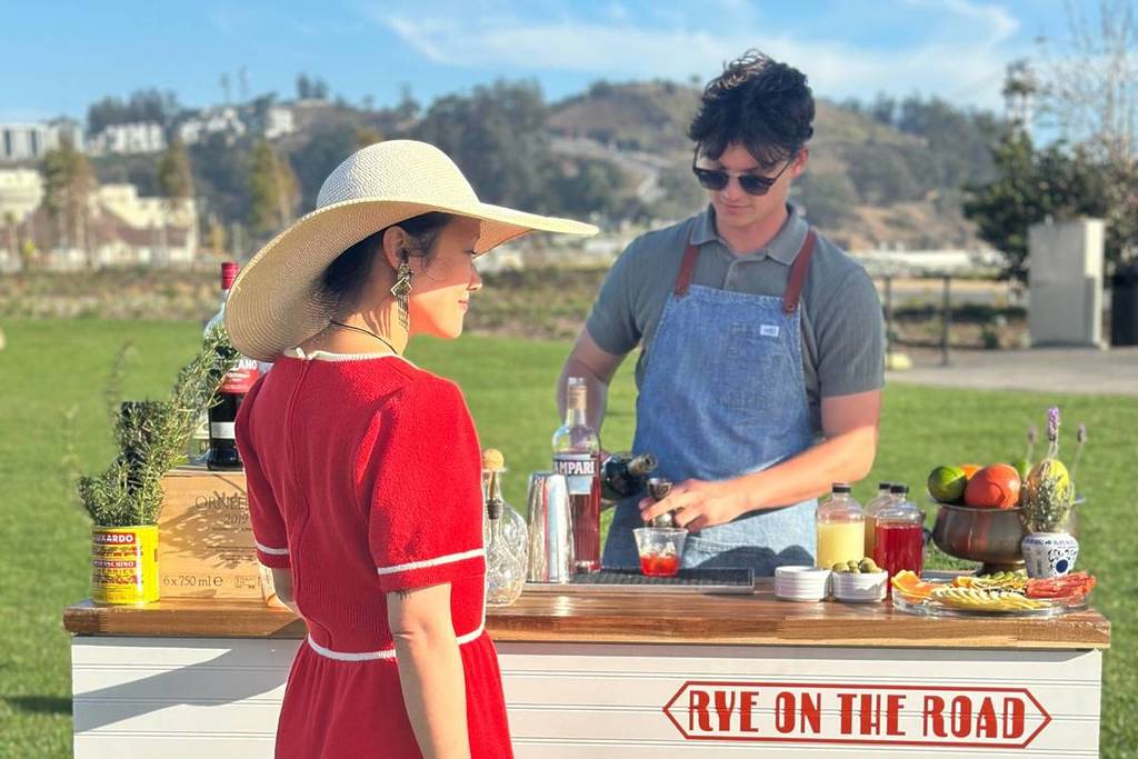 bartender and patron at outdoor bar