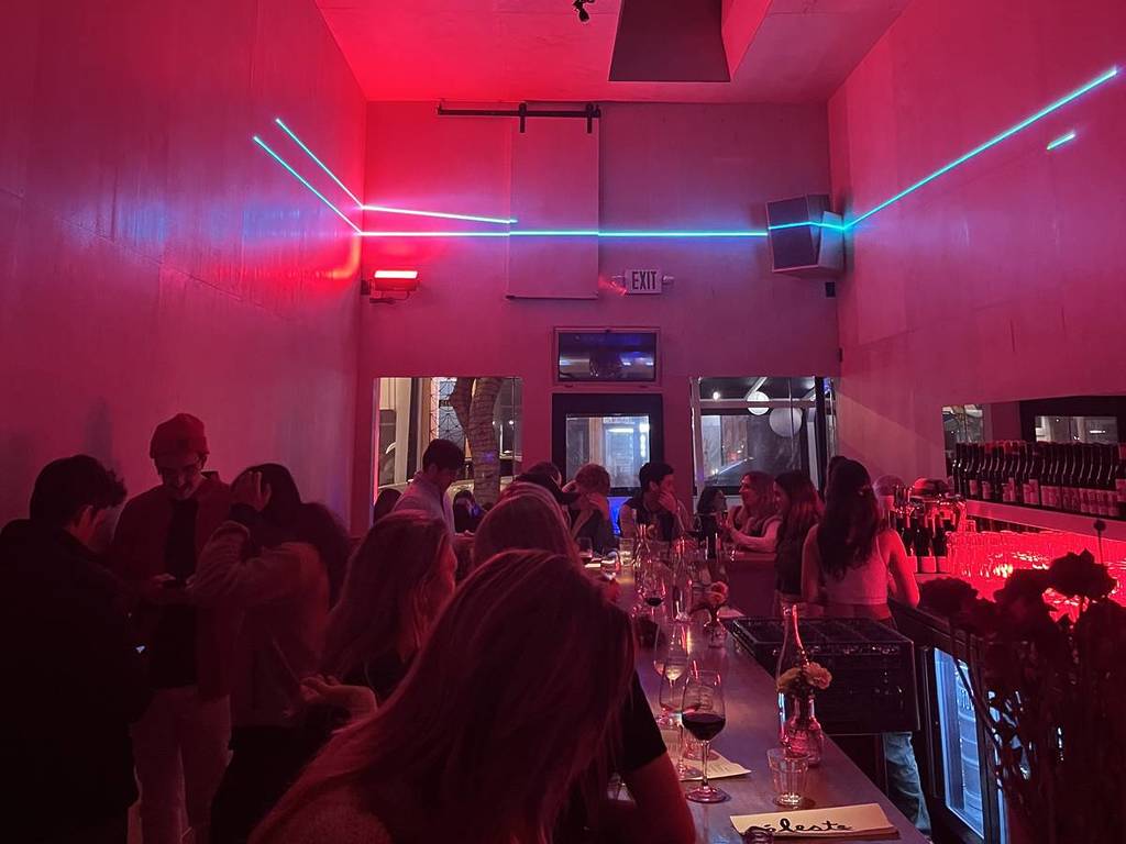 a packed wine bar with neon lights in SF