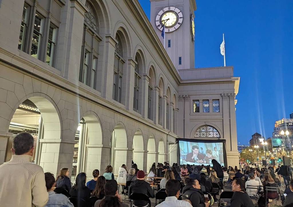 people watching a movie outside the ferry building