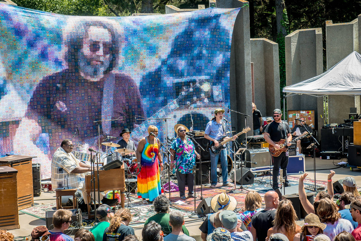 a band playing for an audience in the park