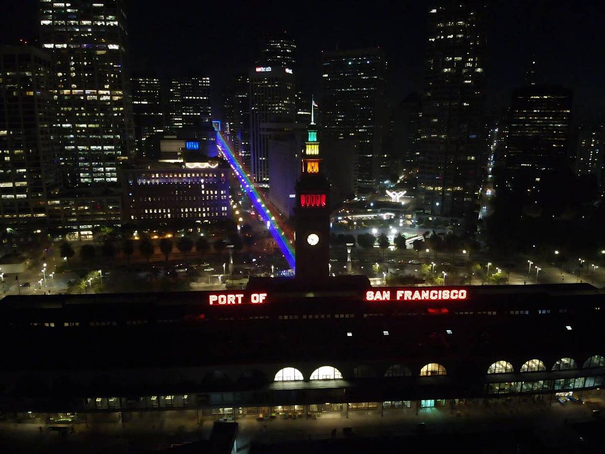a massive pride flag at night in downtown SF