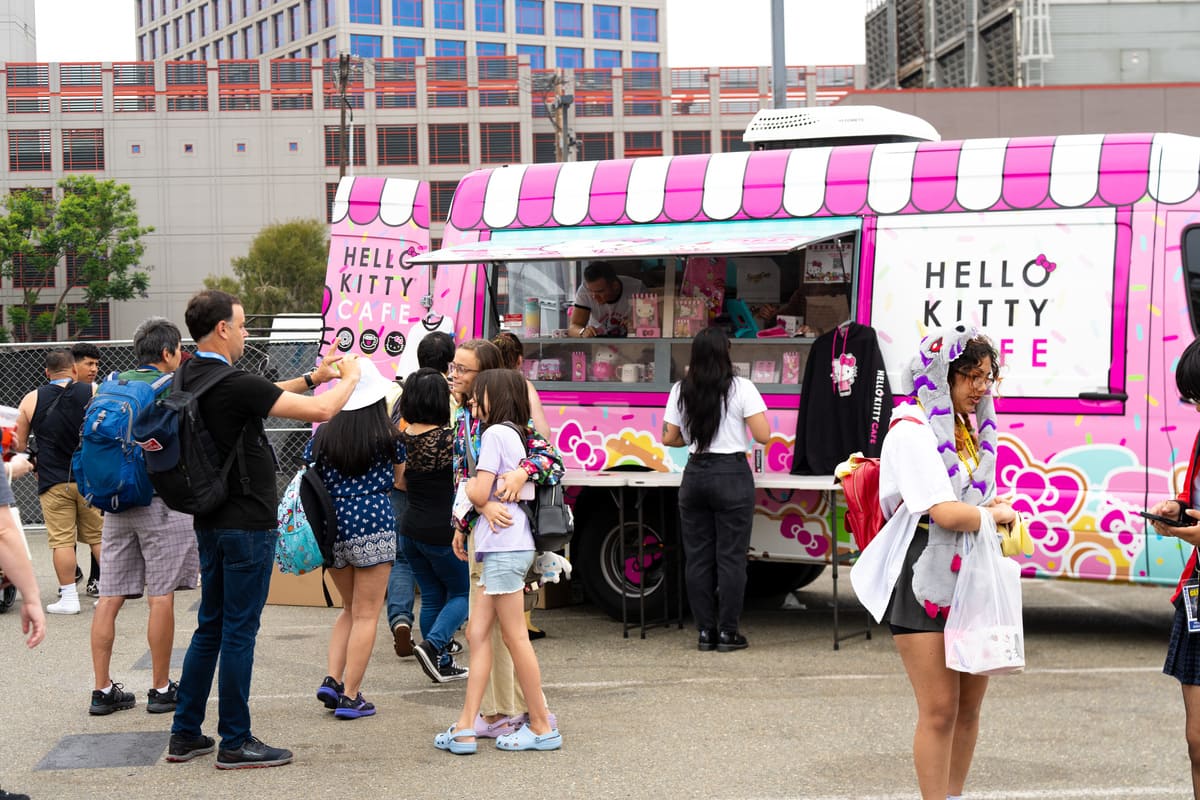 People by treats from the Hello Kitty Cafe Truck