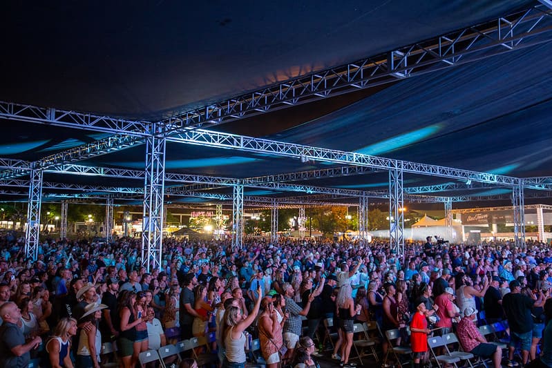 A crowd watches a concert at the CA State Fair.