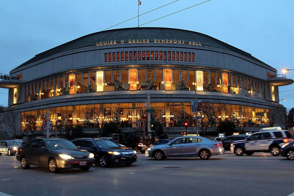The curved exterior of the Louise M Davies Symphony Hall at night.