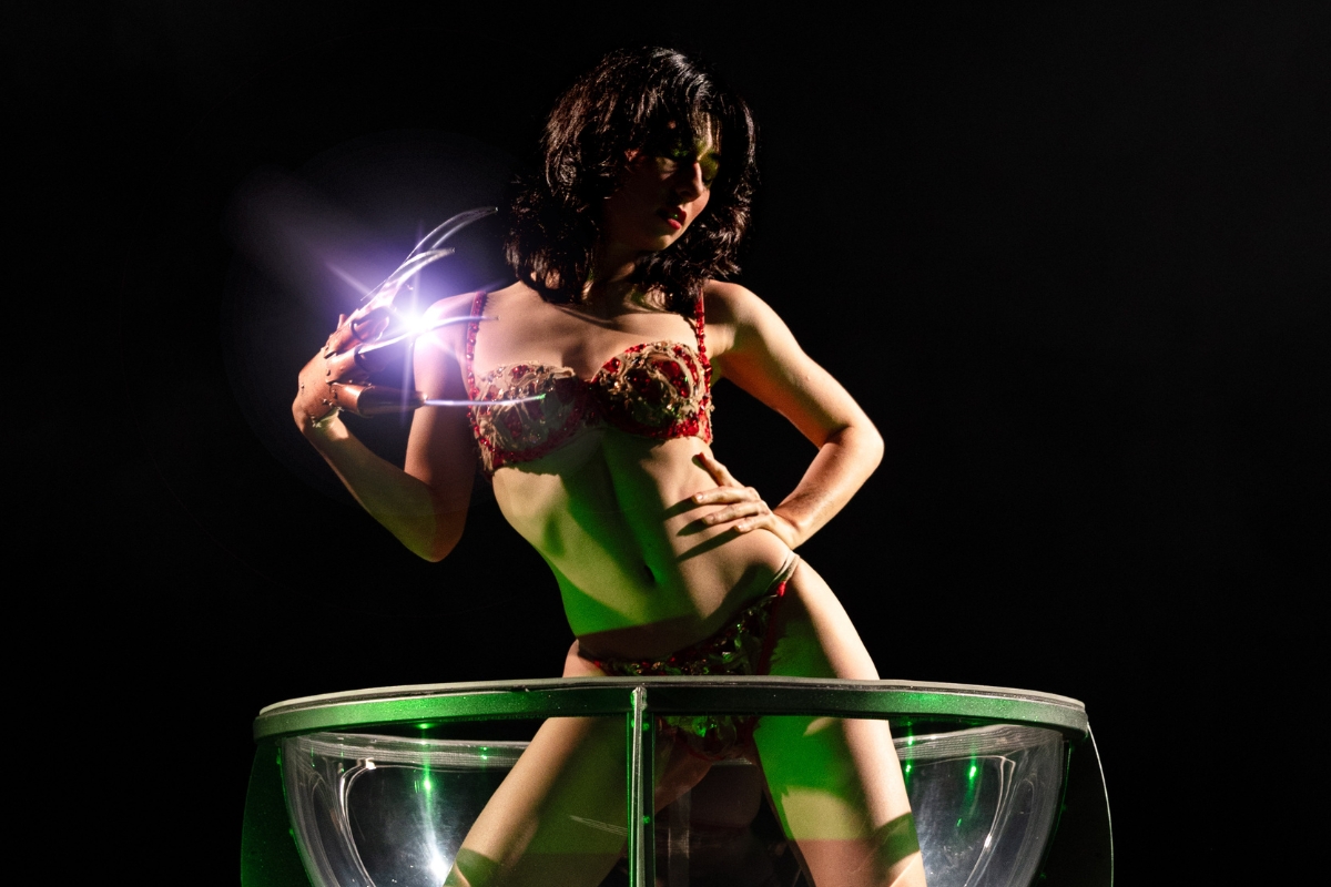 Burlesque performers wear horror-themed outfits