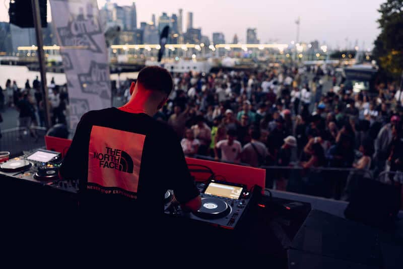 A DJ plays to a crowd at the North Face Climb Festival