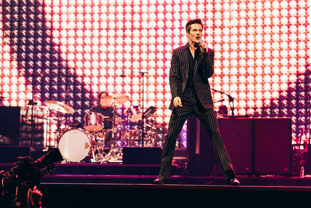 Brandon Flowers and the Killers perform on stage.