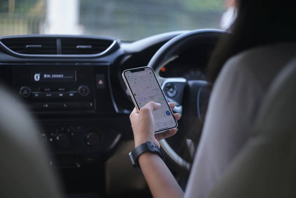 a person looking at a phone while driving