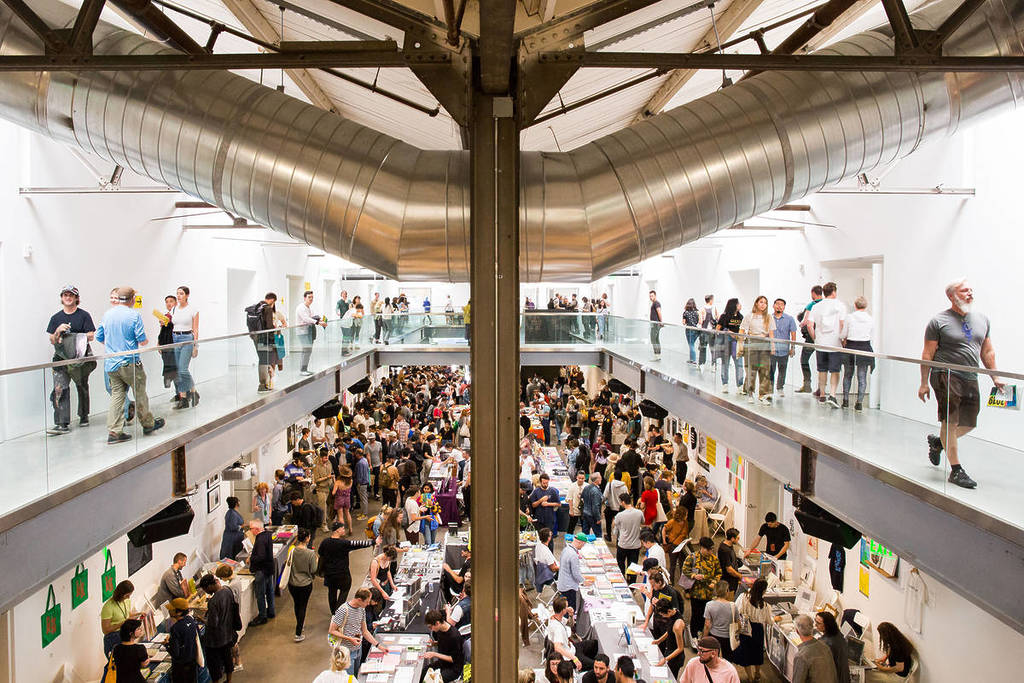 An art fair with many people in a large building