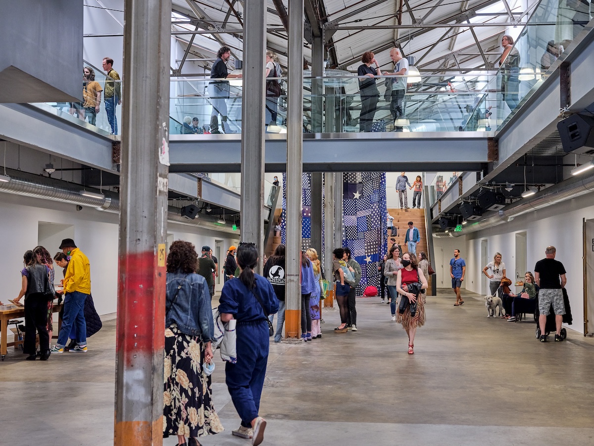 People in a large building looking at art